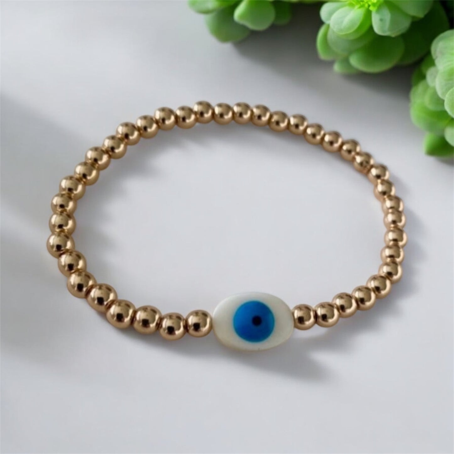 Shine Bright with Protection – Gold Stainless Steel White Evil Eye Bead Bracelet"