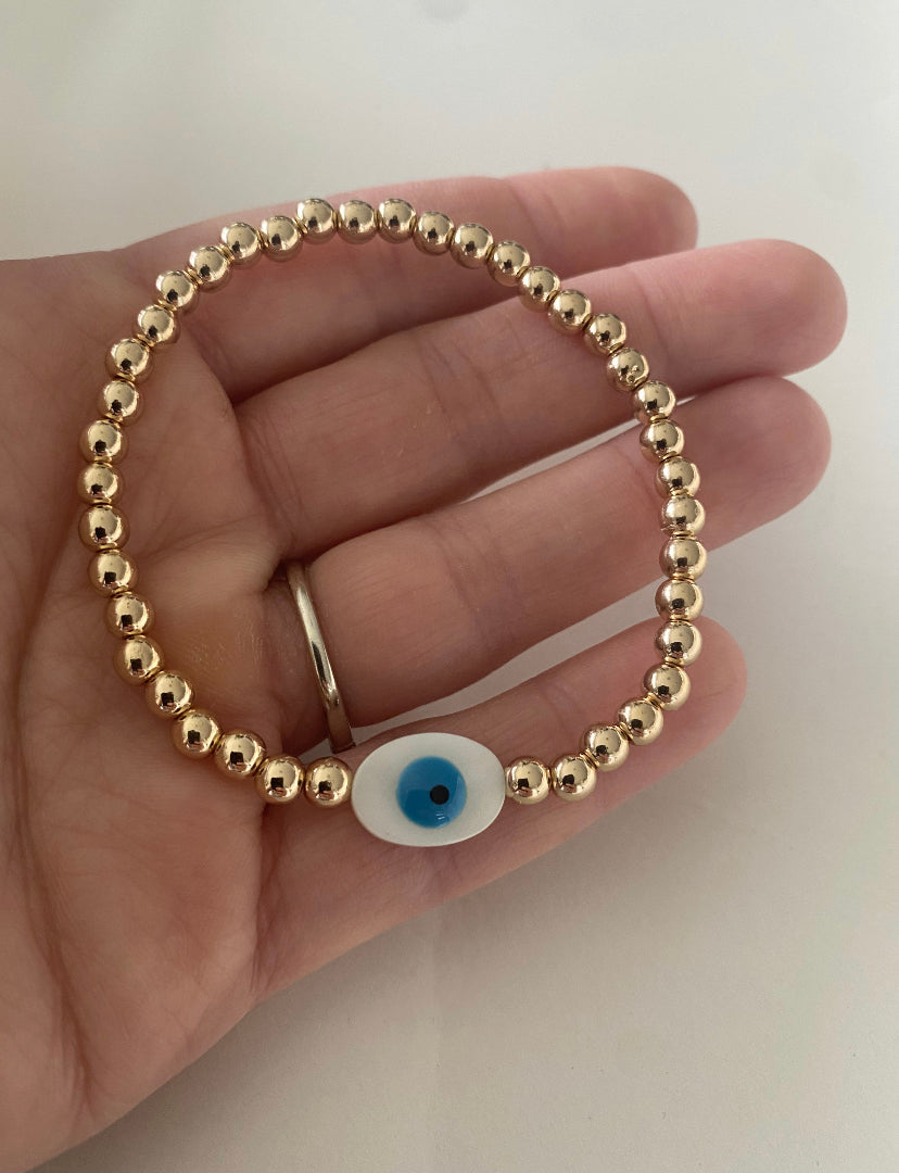 Shine Bright with Protection – Gold Stainless Steel White Evil Eye Bead Bracelet"