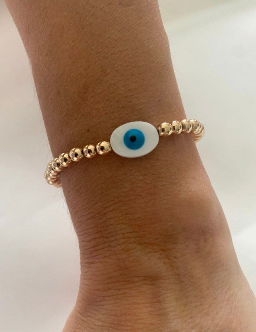 Shine Bright with Protection – Gold Stainless Steel White Evil Eye Bead Bracelet"